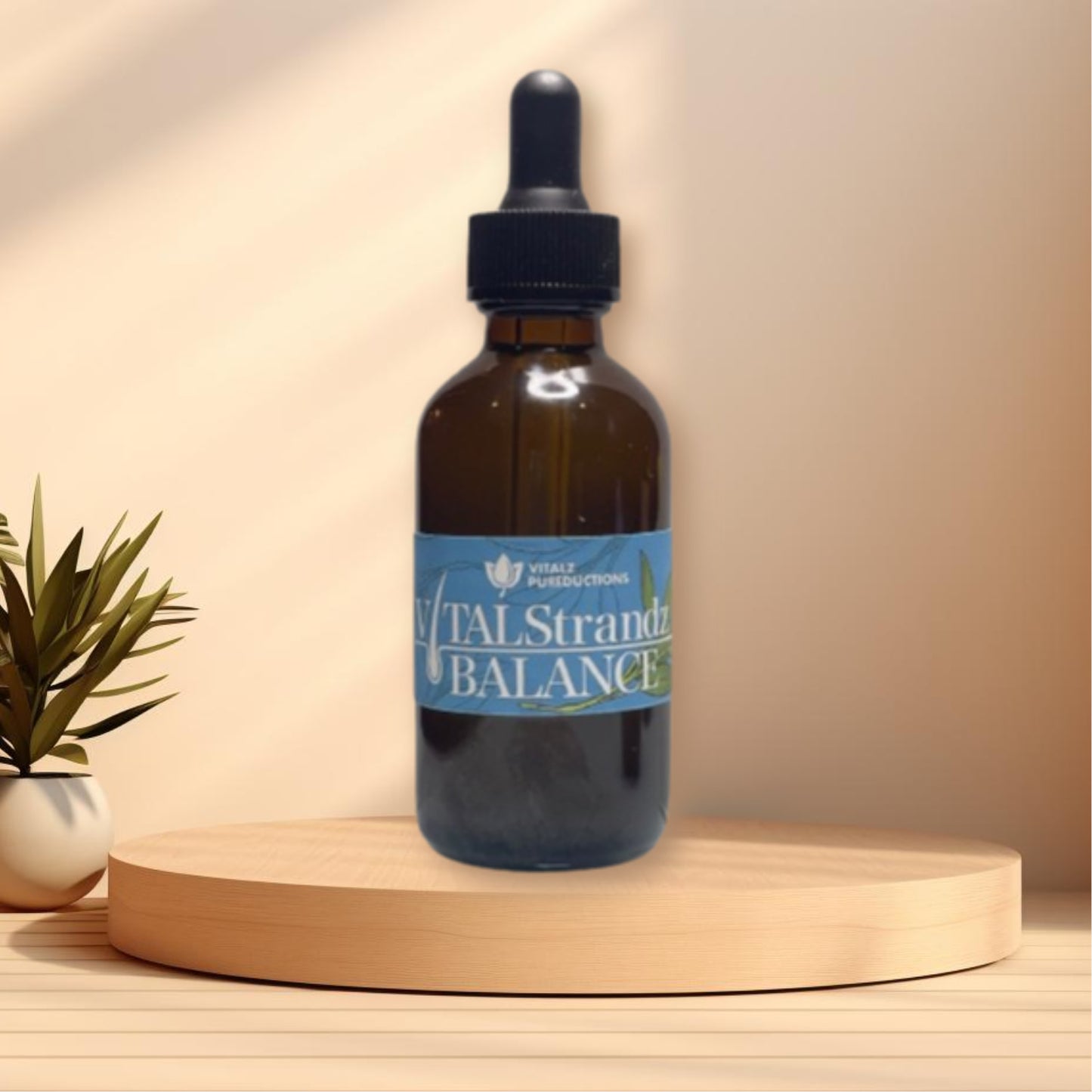 A brown glass dropper bottle labeled "Vital Strandz Balance" is placed on a wooden platform. There is a small plant to the left of the bottle, underscoring the product's focus on scalp health.