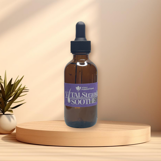 A brown glass dropper bottle labeled "Vital Strandz SOOTHE" is placed on a wooden platform with a small potted plant in the background, promoting scalp health with its nourishing hair loss scalp oils.